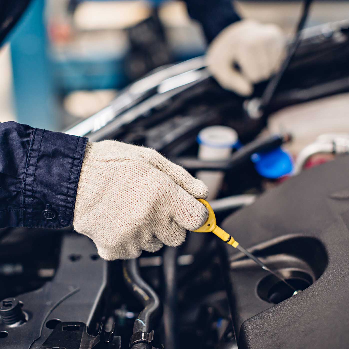 MRC Garage Services mechanic checking oil on car detail